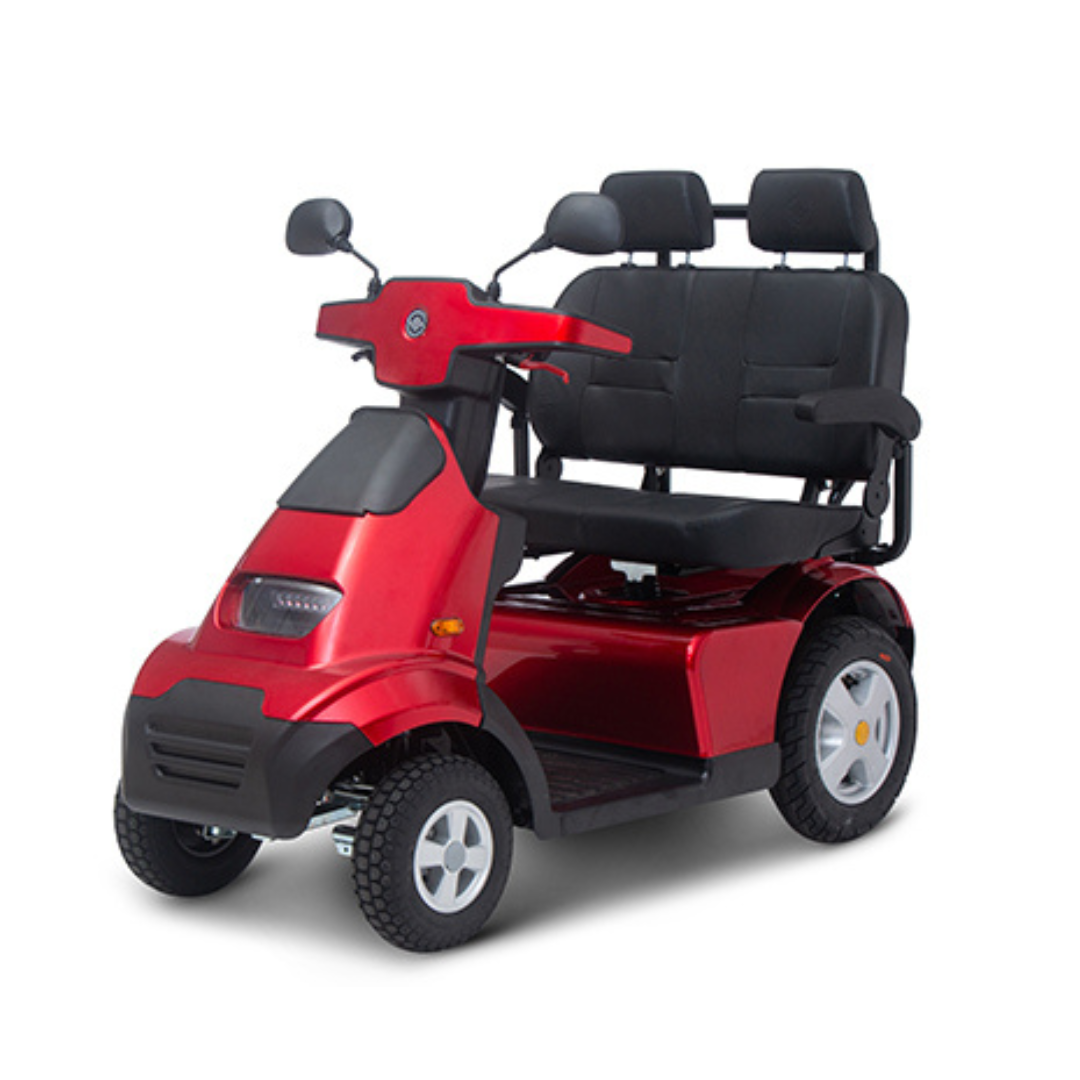 The Afikim Afiscooter S4 HD Bariatric Mobility Scooter features a red design with four wheels, dual black cushioned seats, and mirrors on both handlebars. Built for outdoor adventures, it offers sturdy tires for excellent all-terrain performance.